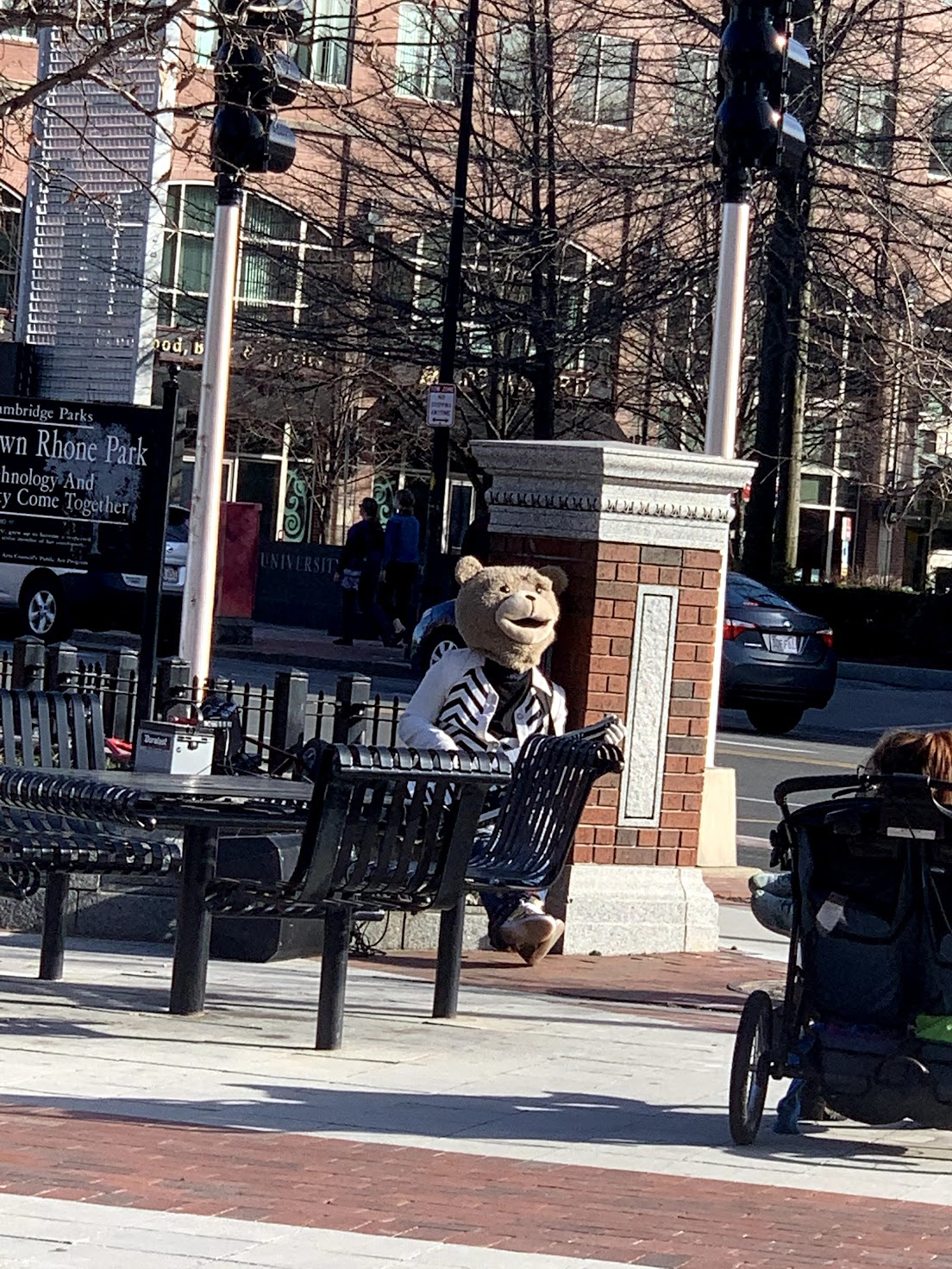 A person in a bear costume and a spiffy outfit takes a break from jamming on the guitar.