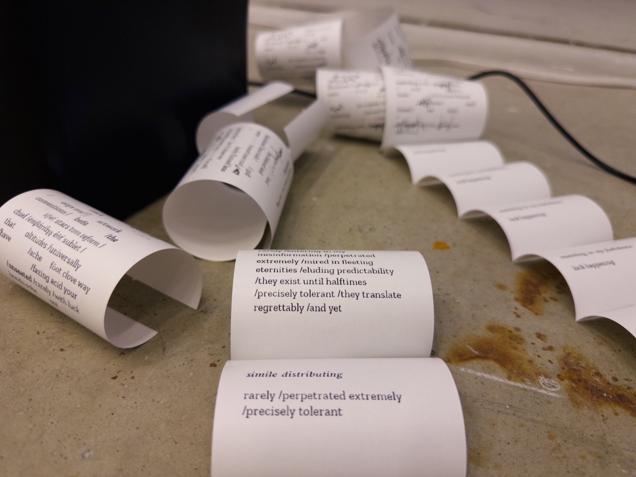 a poem printed on receipt paper in a bed of leaves